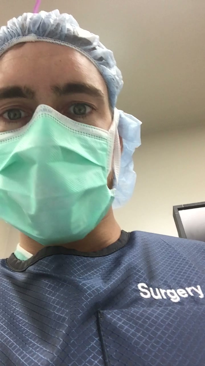 Nathaniel in surgical mask and scrubs in the operating room